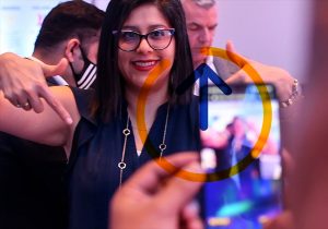 A woman is taking a picture with her phone.