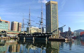 A tall ship docked in a body of water.