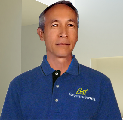 A man in a blue shirt standing in a room.