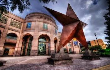 A statue of a star in front of a building.