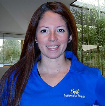 A woman in a blue shirt posing for a photo.