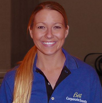 A woman in a blue shirt smiling.