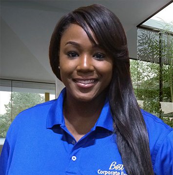 A woman in a blue polo shirt smiling.