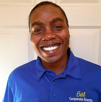 A man in a blue shirt smiling.