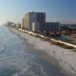 An aerial view of a beach and buildings.