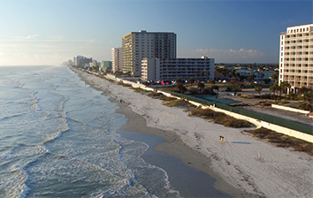 An aerial view of a beach and buildings.