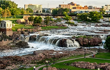 A team building activity at a city park in Sioux falls with a beautiful view of a waterfall.