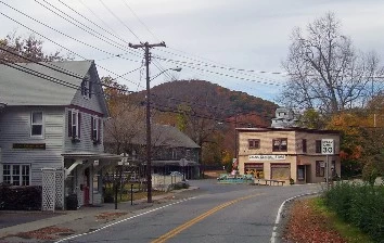 Wassaic team building takes place on a street in a small town, with a mountain in the background.