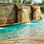 A team building activity in Westlake, TX featuring a swimming pool with a waterfall centerpiece.