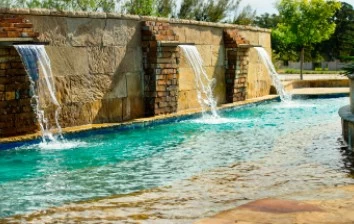 A team building activity in Westlake, TX featuring a swimming pool with a waterfall centerpiece.