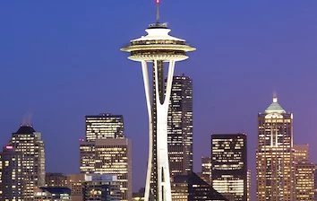 The space needle in Seattle is lit up at dusk and provides a fun atmosphere for corporate events.