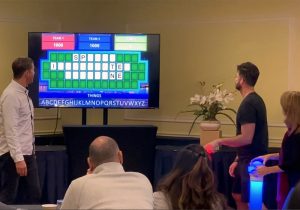 A group of people in front of a tv playing a game.