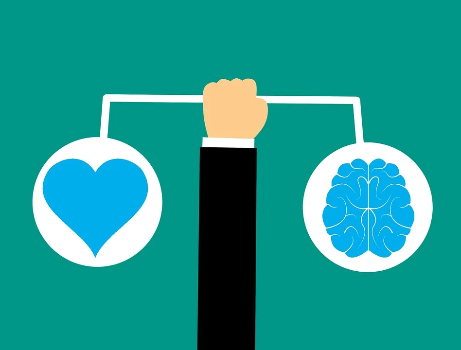 A hand holding a scale with a heart and a brain on it, representing the concept of emotional intelligence.