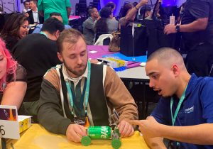 A group of people at a table playing a game.