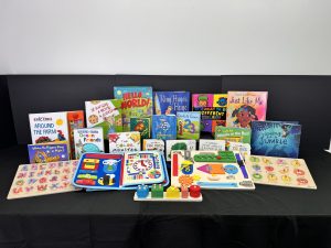 Assorted children's educational books and learning toys displayed on a table, including alphabet and counting games.