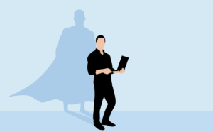 A person stands holding a laptop, their shadow behind them in the shape of a superhero wearing a cape—rising above the challenges of a bad boss.