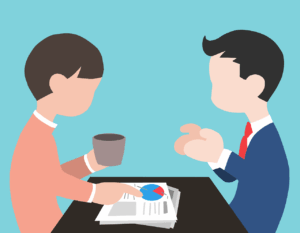 Two faceless people sit at a table; one holds a cup while the other points at a chart on papers, suggesting a discussion or meeting about how to reduce employee training costs.