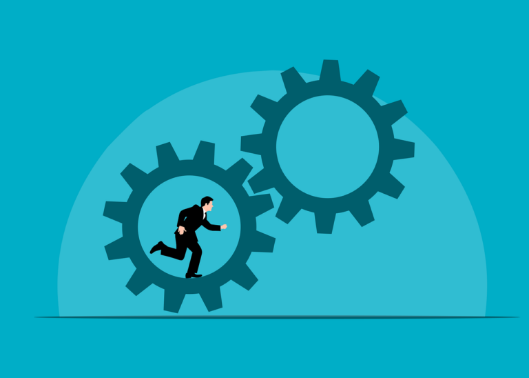 A person in a business suit running inside a large gear, embodying learning by doing, with another large gear nearby on a blue background.