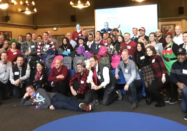 A group of people posing for a photo in a room.