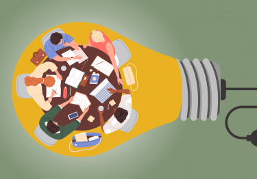 Top-down view of a diverse team demonstrating dynamic interactions, seated around a table cluttered with laptops, notebooks, and coffee mugs, symbolized as being inside a light bulb.