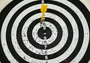 A dart is in the center of a target.